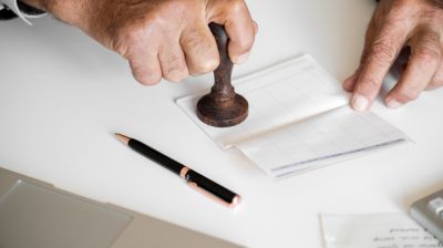 people-checking-bankbook-isolated-white-table